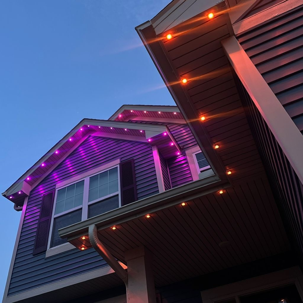 Close-up of permanent LED track lighting in purple and orange at dusk